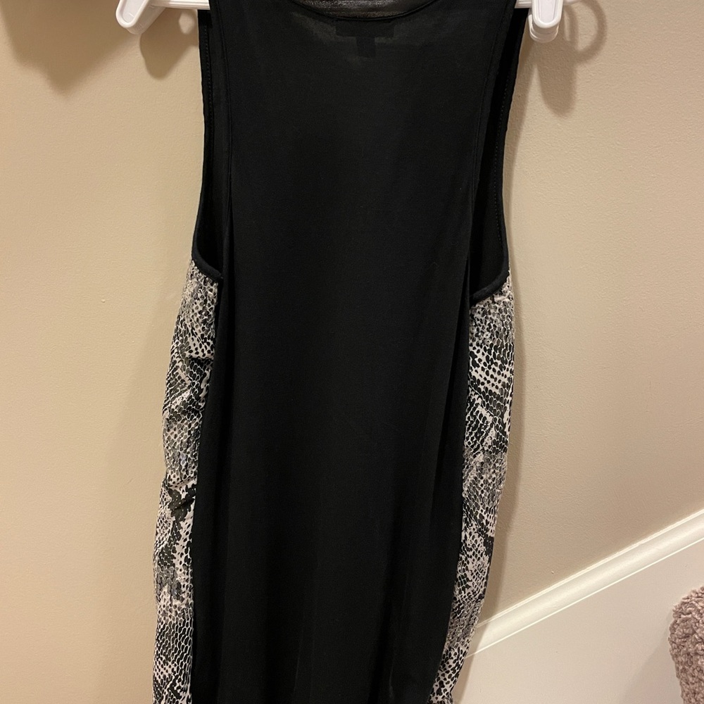 Has some sparkle.  Black faux snake skin tank